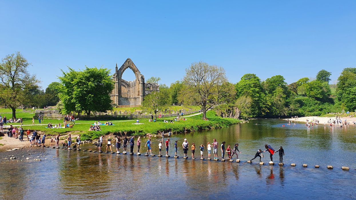 <p>Tackling the stepping stones at Bolton Abbey in North Yorkshire</p>