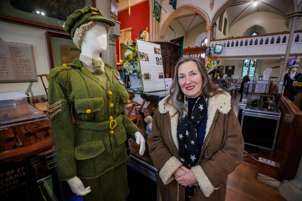 Tansy Forster beside a life-size figure of her grandmother