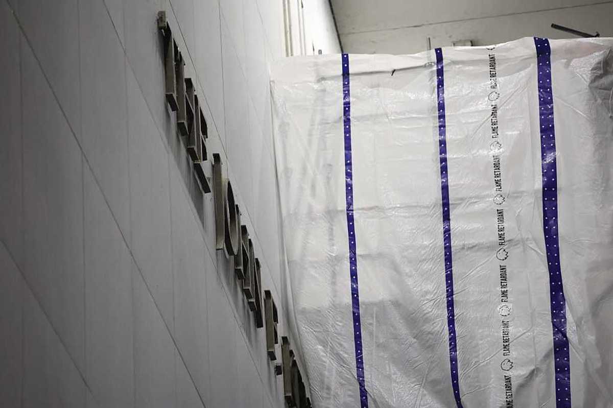 Tarpaulin covers part of a wall of the John F. Kennedy Center for the Performing Arts as Donald Trump's name is removed from the building.