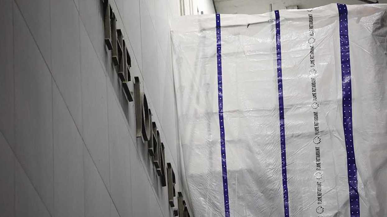 Tarpaulin covers part of a wall of the John F. Kennedy Center for the Performing Arts as Donald Trump's name is removed from the building.