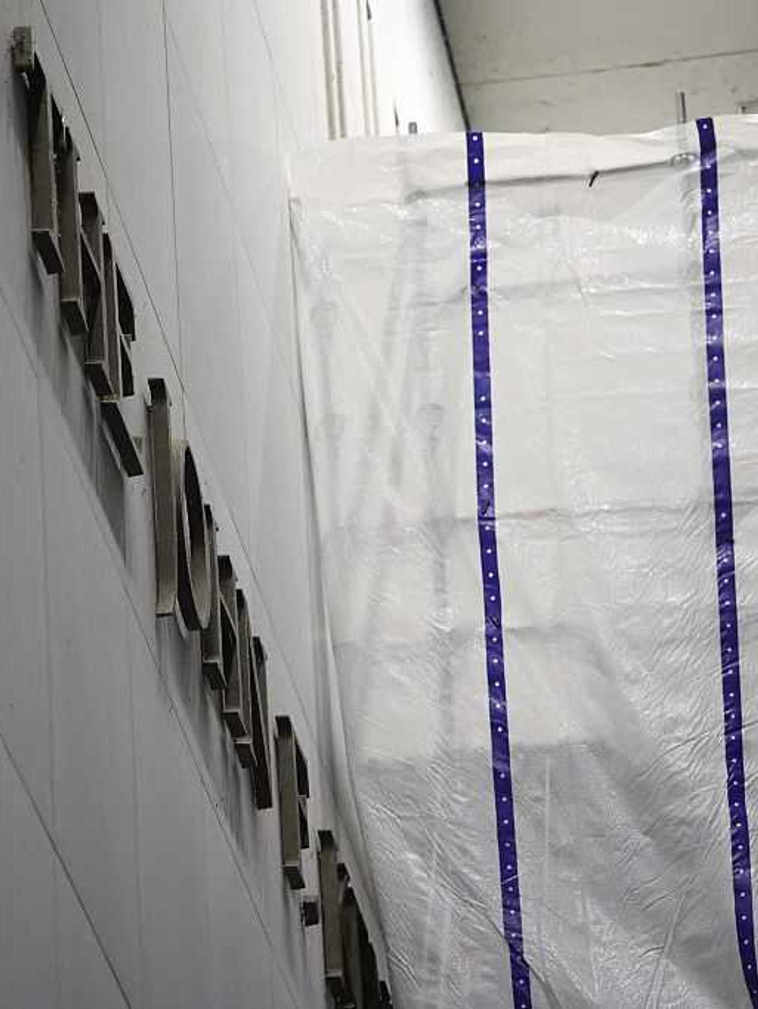 Tarpaulin covers part of a wall of the John F. Kennedy Center for the Performing Arts as Donald Trump's name is removed from the building.