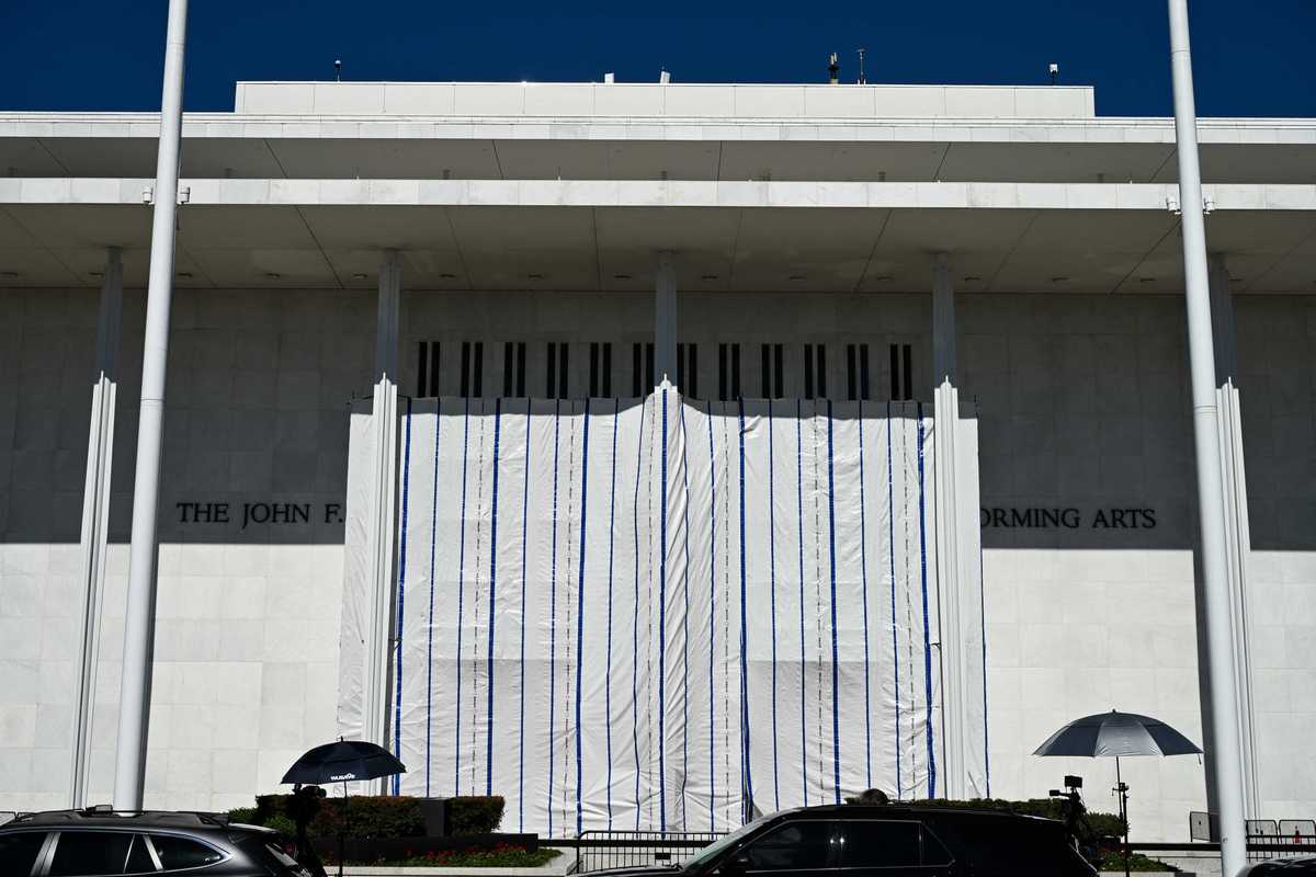 Tarpaulin covers the front of the John F. Kennedy Center for the Performing Arts.
