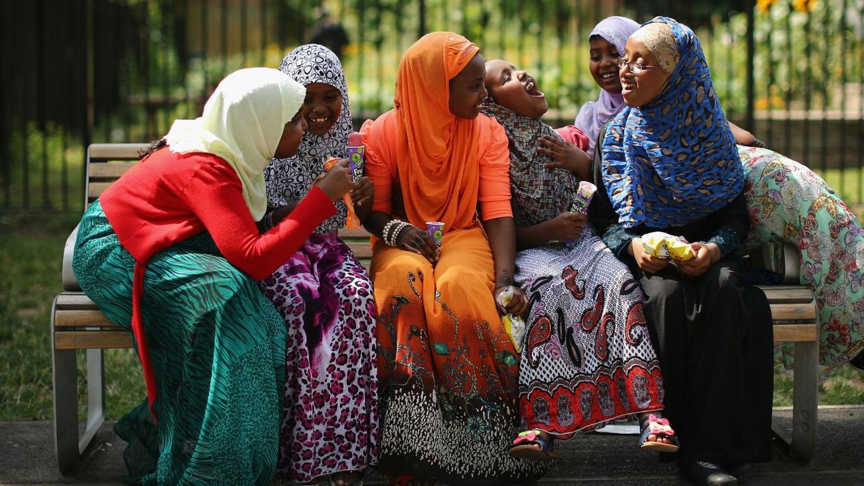 Teenagers celebrate Eid at the end of Ramadan in Burgess Park, London on August 8, 2013