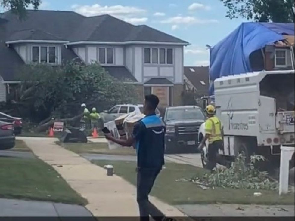 The Amazon employee delivers several packages amid the tornado\u2019s aftermath.
