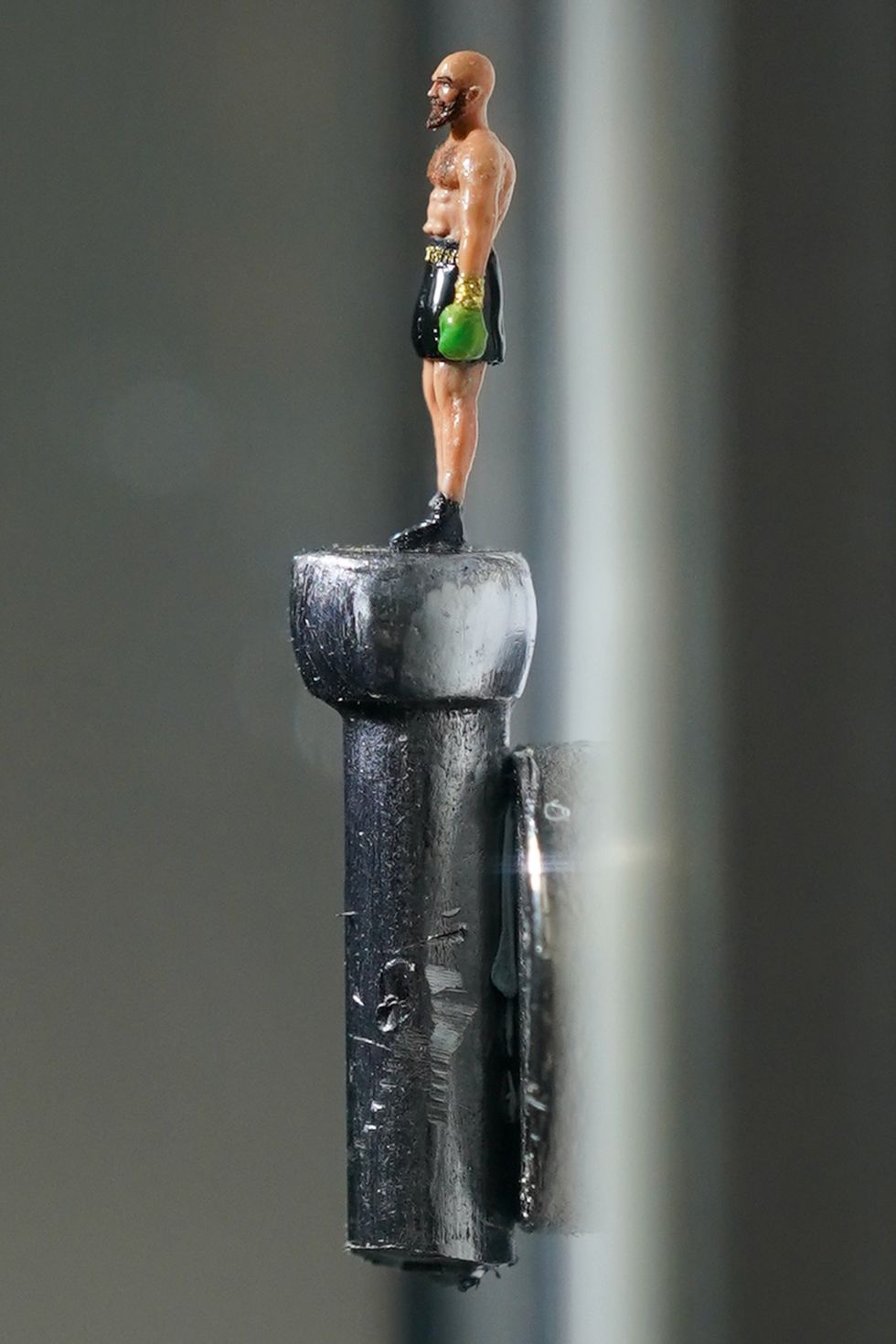 The artwork is displayed on the head of a nail (Jacob King/PA)