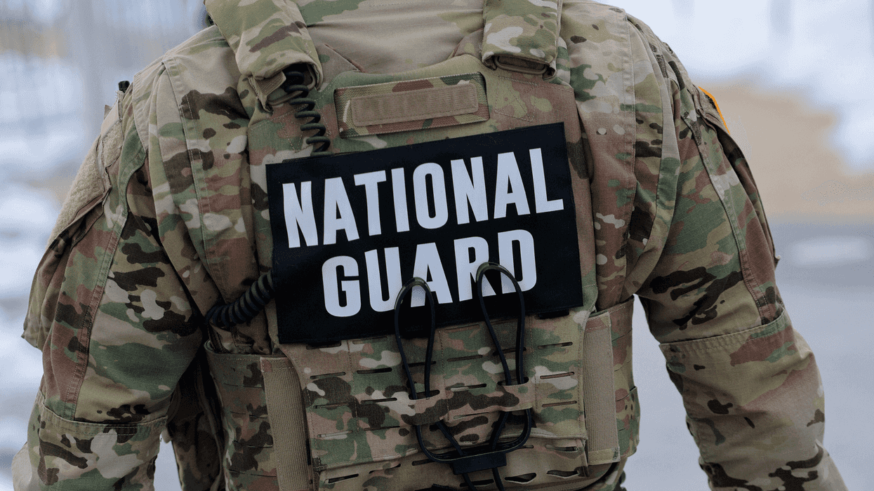 The back of a man in National Guard uniform.