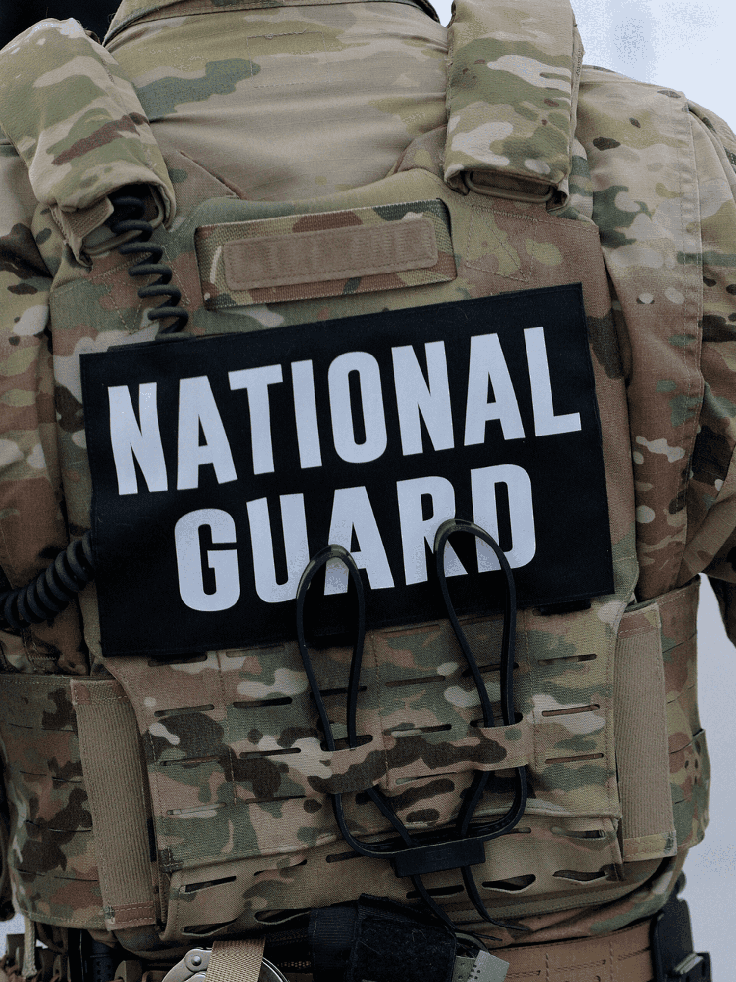The back of a man in National Guard uniform.
