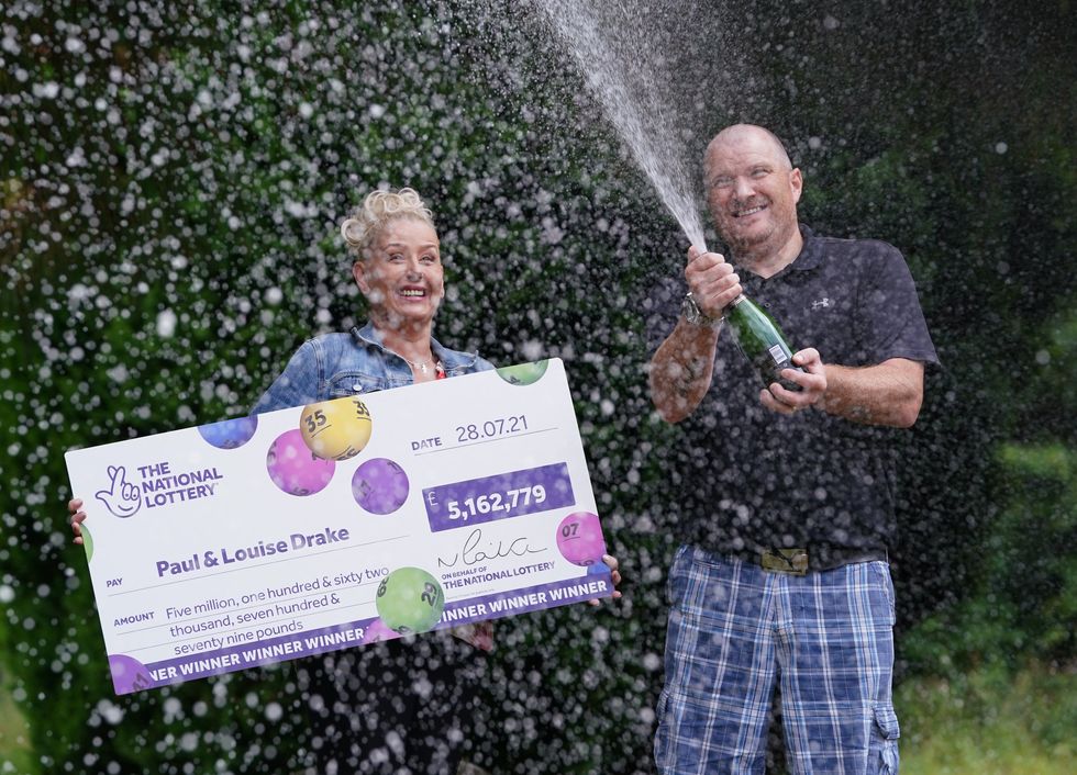 The couple celebrate their win with champagne (Andrew Milligan/PA)