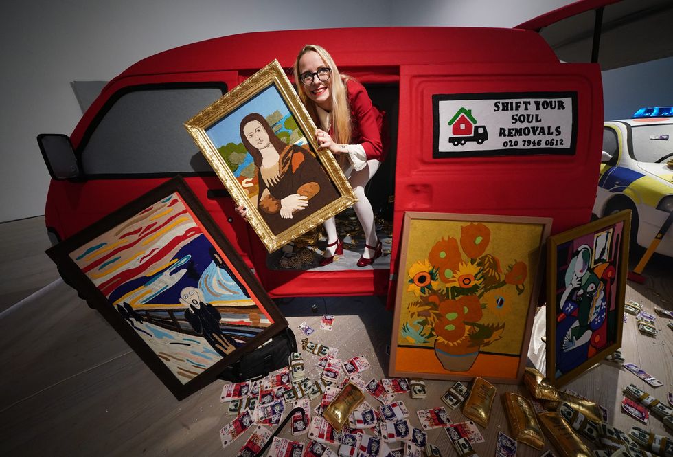 The criminal gang have fled the scene, leaving behind their getaway van filled with their illicit haul (Yui Mok/PA)