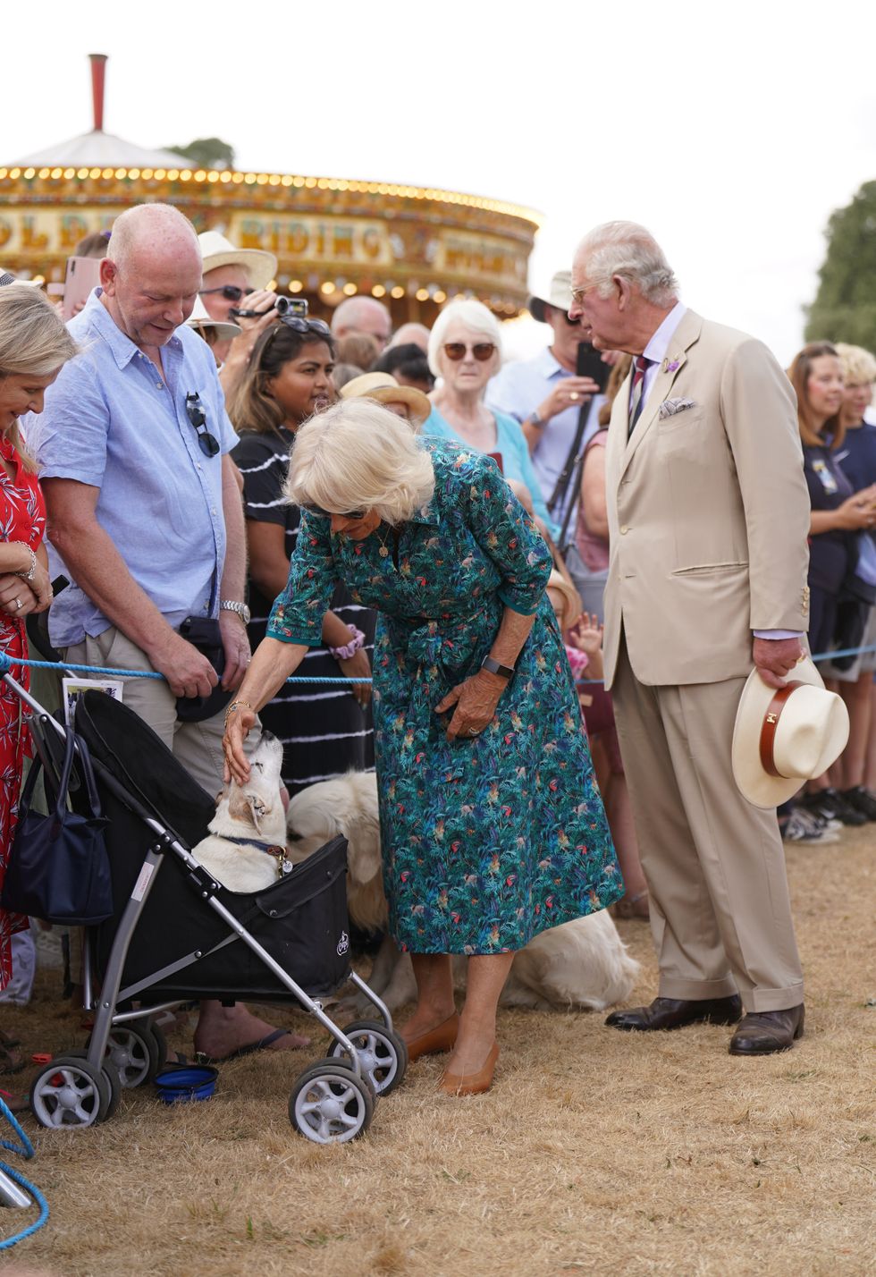 Duchess of Cornwall admires dog in a buggy at Sandringham Flower Show