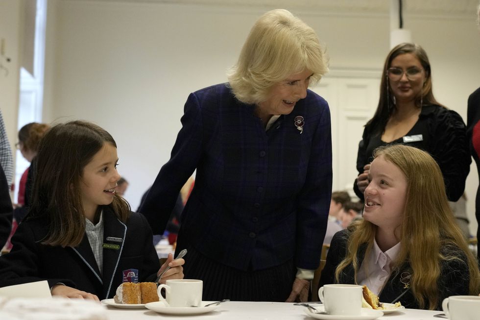 The Duchess of Cornwall talks to schoolchildren during the tea party at the Royal Geographical Society (Frank Augstein/PA)