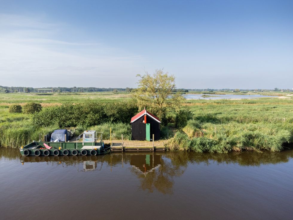 The Eel Sett building near a river in the Norfolk Broads