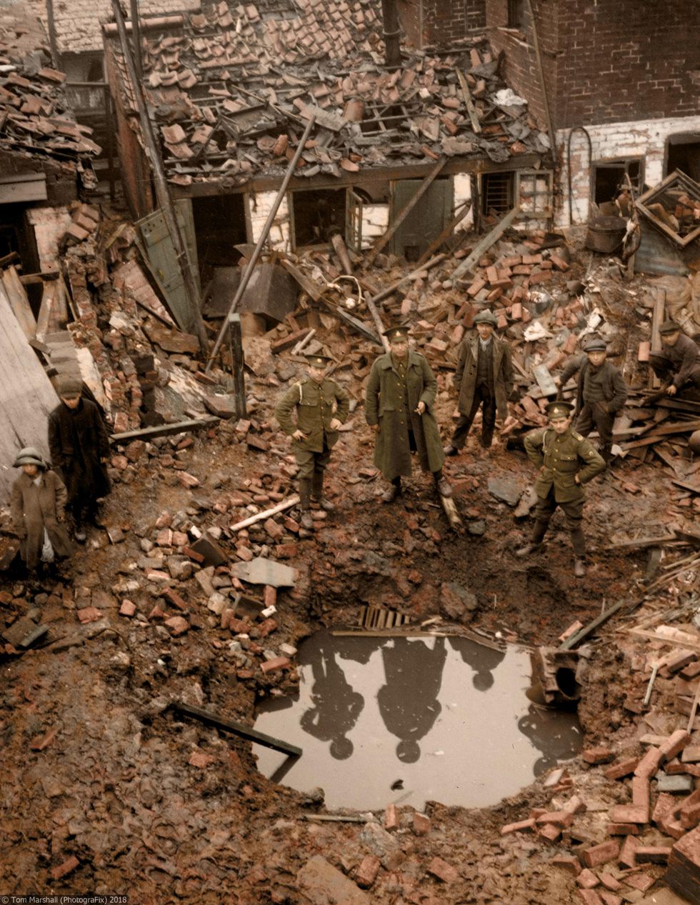 The extent of the devastation caused by Zeppelin bombs could be extreme. Here, First World War soldiers and civilians are seen crowding around a crater in England.