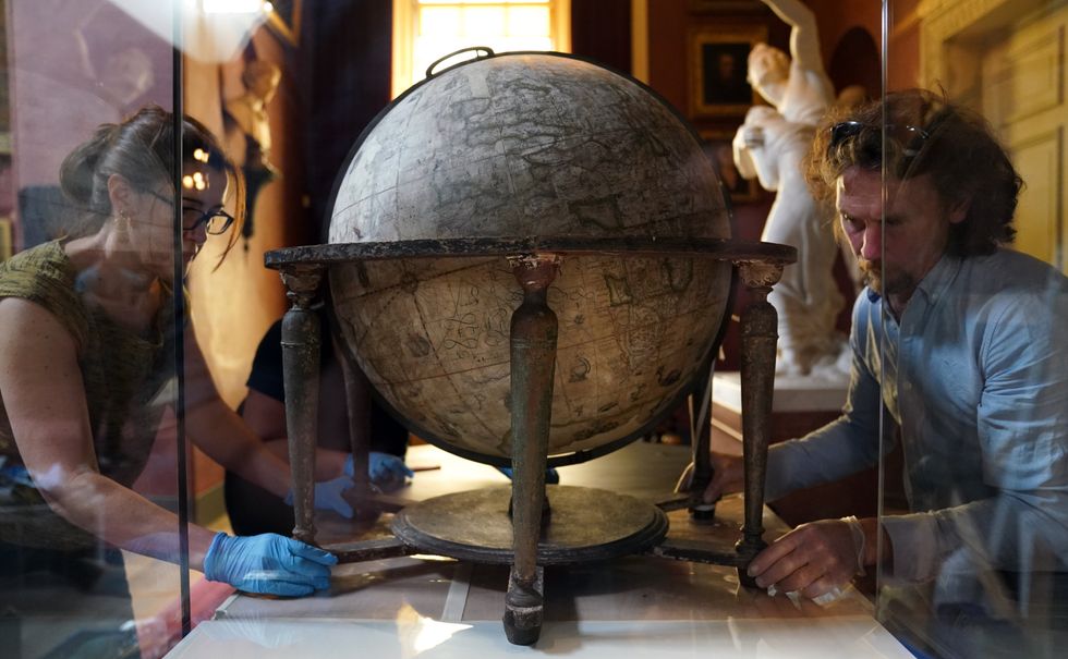 The globe has a new display case at Petworth House in West Sussex (Andrew Matthews/PA)