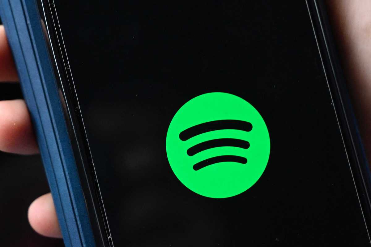 The green Spotify logo on an iPhone screen.