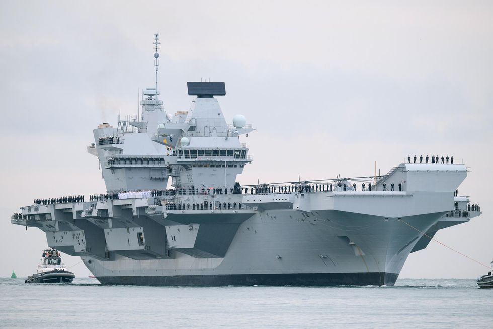 The HMS Queen Elizabeth supercarrier heads into port on August 16, 2017 in Portsmouth, England. The HMS Queen Elizabeth is the lead ship in the new Queen Elizabeth class of supercarriers. Weighing in at 65,000 tonnes she is the largest war ship deployed by the British Royal Navy.