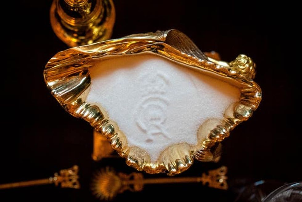 The King Charles III cypher imprinted into salt on the banquet table in St George's Hall