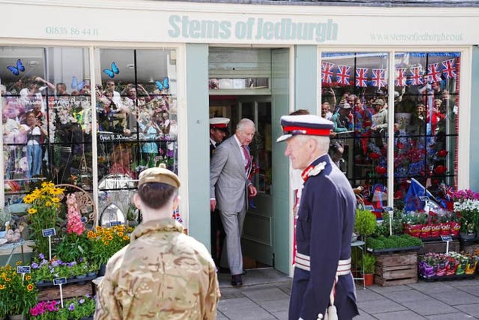 The King exiting a shop