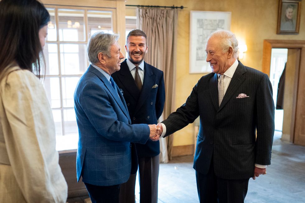 The King greeting Alan Titchmarsh, watched by Sir David Beckham, at Highgrove