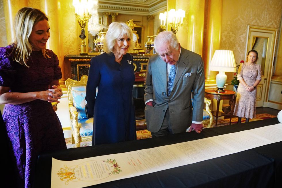 King and Queen view historic Coronation Roll