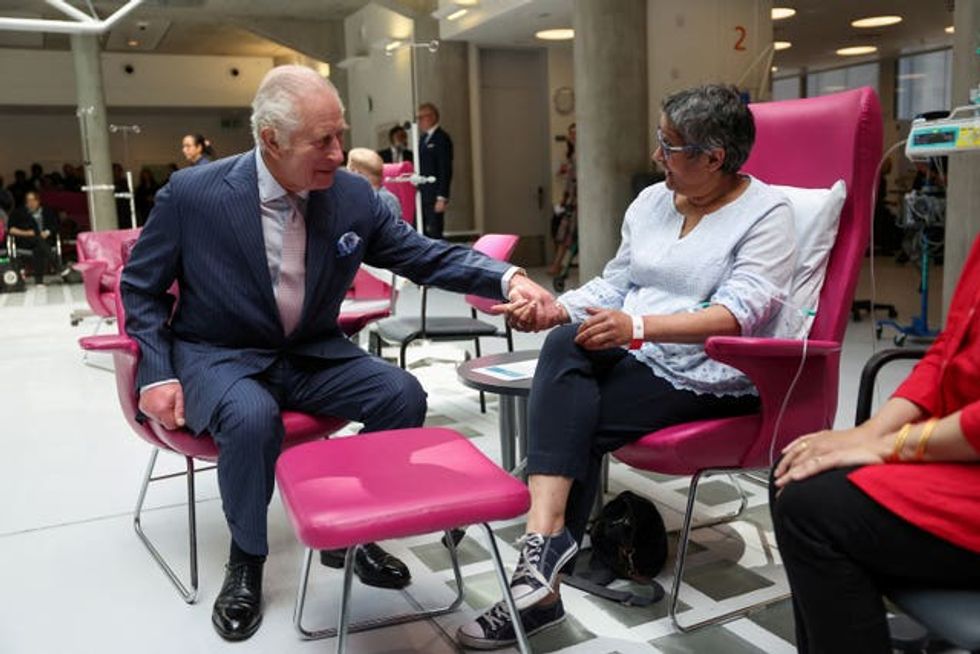 The King, patron of Cancer Research UK and Macmillan Cancer Support, meets patient Asha Millan at the University College Hospital Macmillan Cancer Centre last year