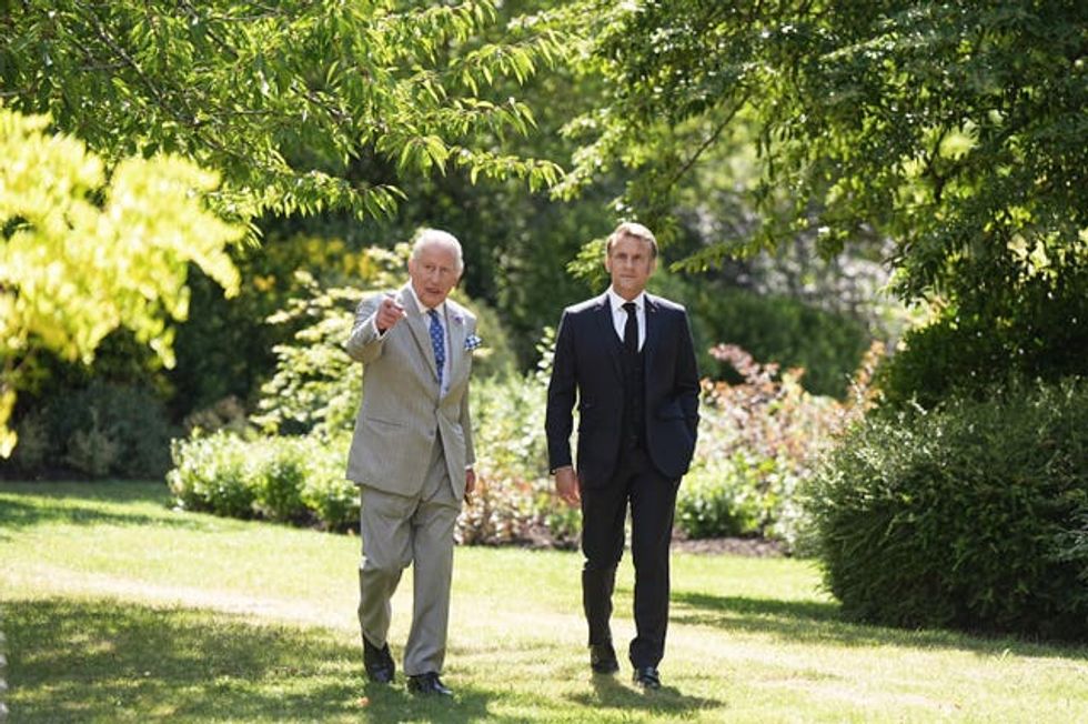 The King showing President of France Emmanuel Macron one of the gardens at Windsor Castle during the state visit in 2025