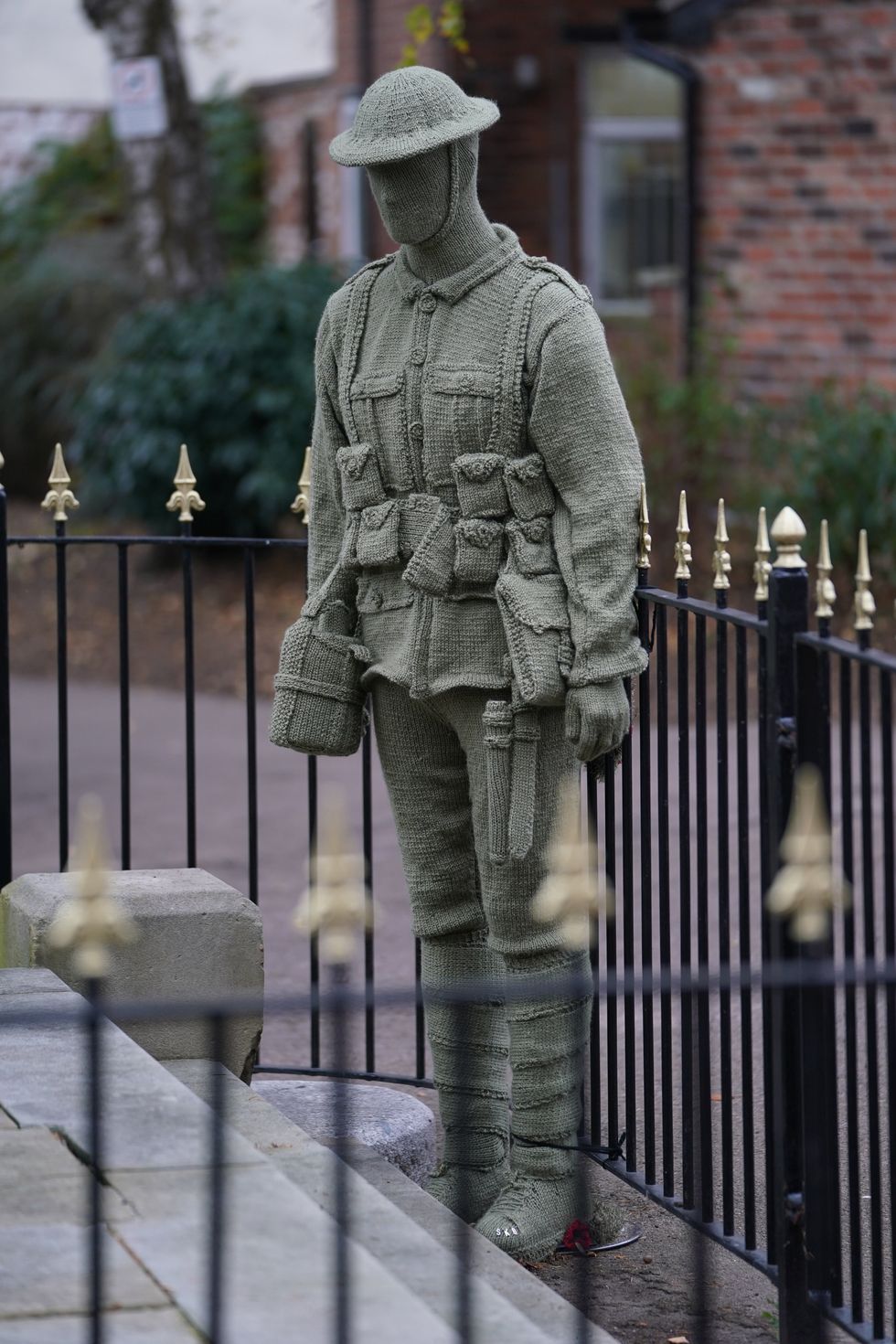 The knitted soldier has been placed next to the War Memorial Clock Tower in Syston, Leicestershire (Mike Egerton/PA)