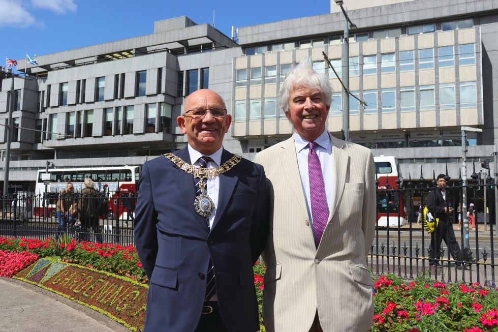 The Lord Provost of the City of Edinburgh, Robert Aldridge, with Sir Andrew Cubie, chair of the Trellis charity, which has been celebrated by the city's annual floral clock display (Danyel VanReenen/PA)