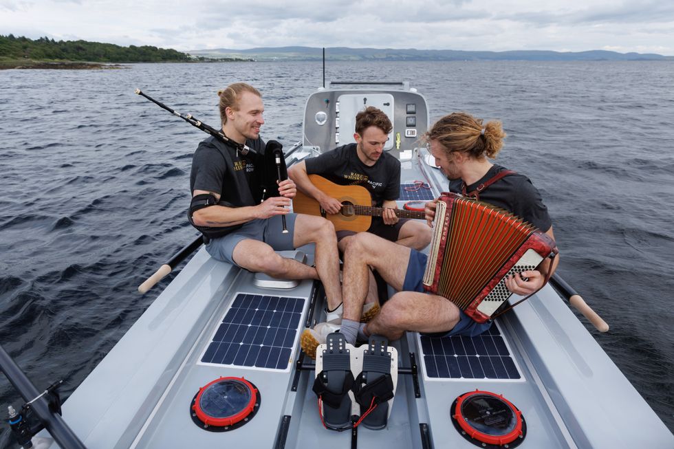 The Maclean brothers playing musical instruments on their boat