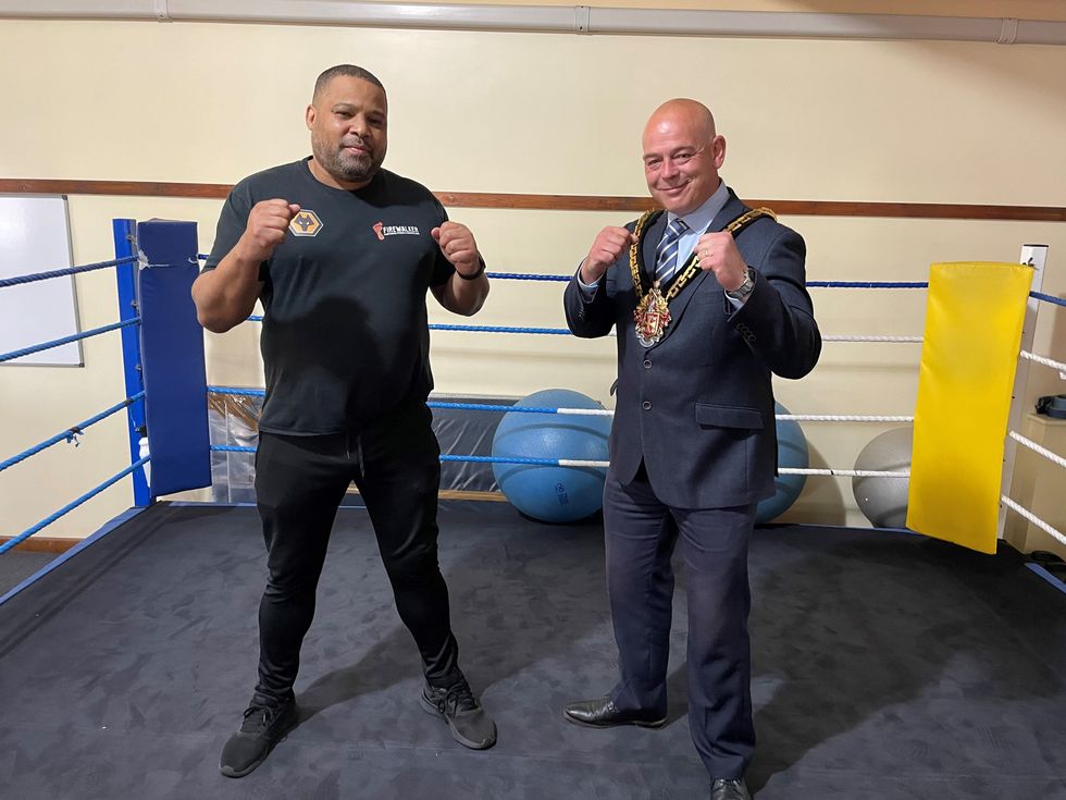 The Mayor of Wolverhampton, Greg Brackenridge, and the owner of Firewalker boxing club, Kirkwood Walker, pose in the ring as they celebrate the silver medal won by Ben Whittaker (Phil Barnett/PA)