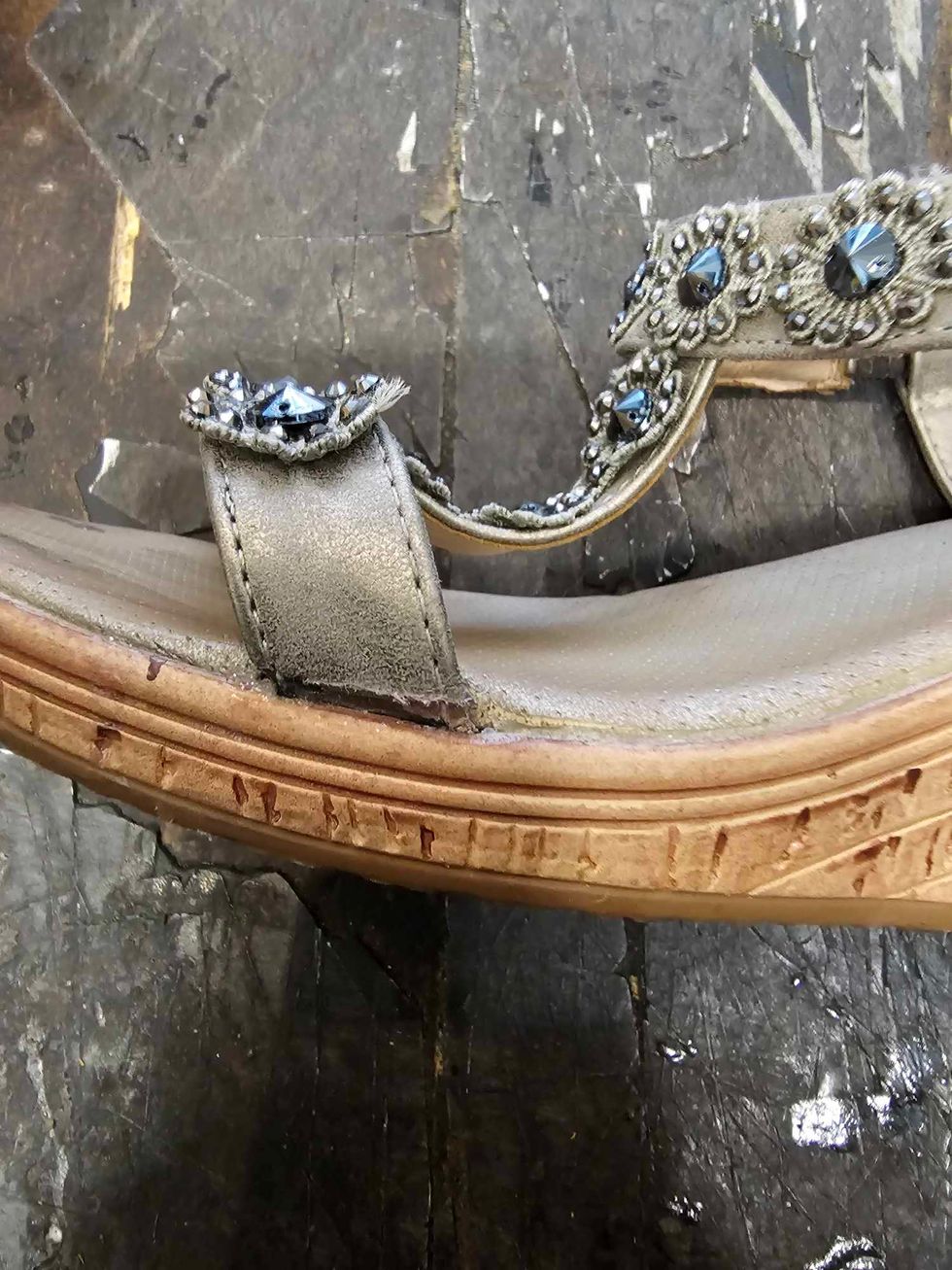 The mended strap on the broken shoe