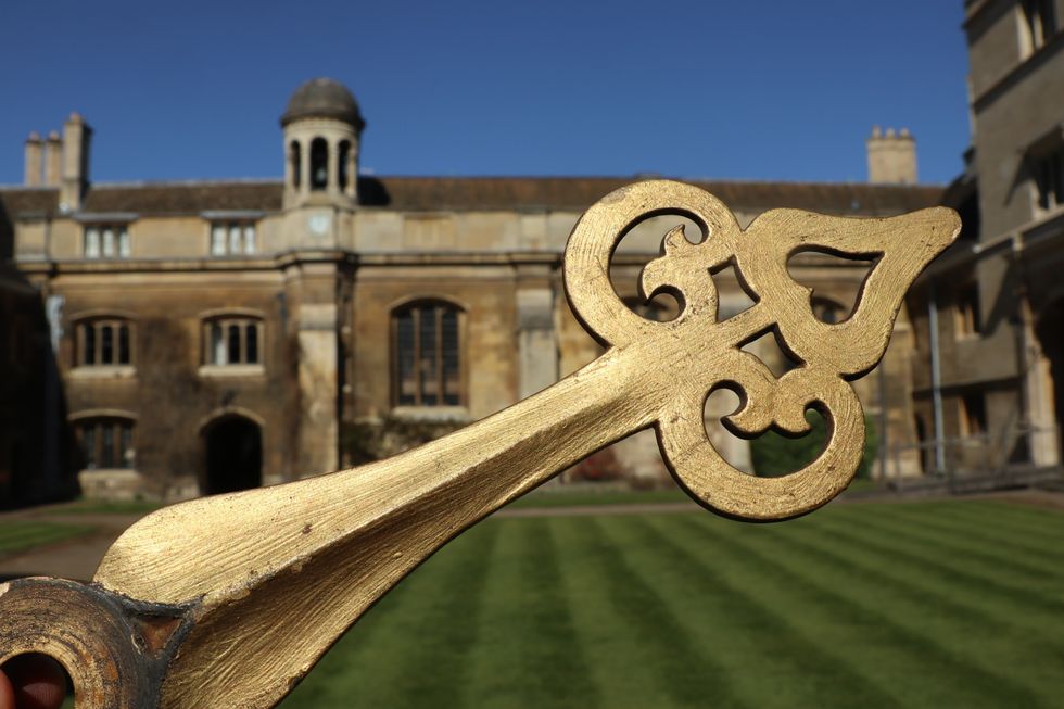 Missing hand from Cambridge College clock returned decades after student prank