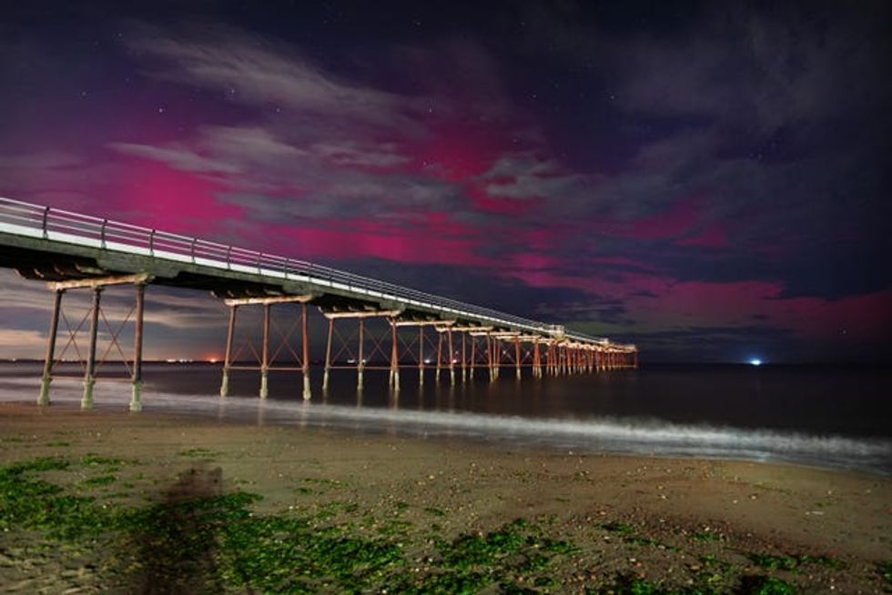The Northern Lights visible through clouds over Saltburn-by-the-Sea in North Yorkshire on Tuesday morning