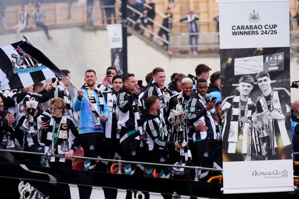 The open top buses carrying the Newcastle United players passes by St James\u2019 Park, during the Carabao Cup trophy parade in Newcastle