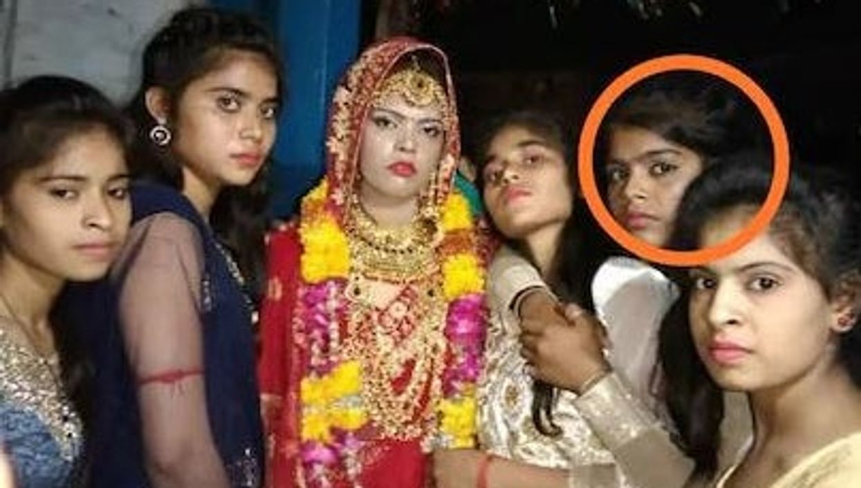 <p>The original bride (centre) alongside her younger sister (circled) who would go on to replace her at the ceremony</p>