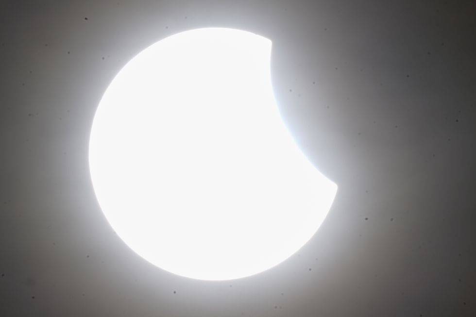 Skygazers catch glimpse of partial solar eclipse