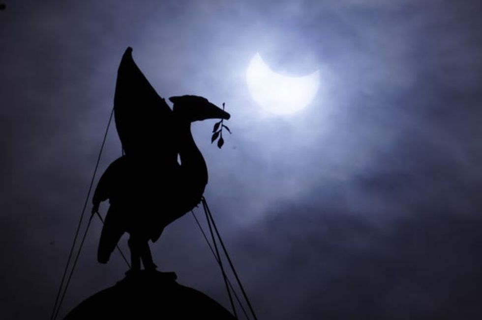 The partial solar eclipse as seen over The Royal Liver Building on Liverpool\u2019s waterfront