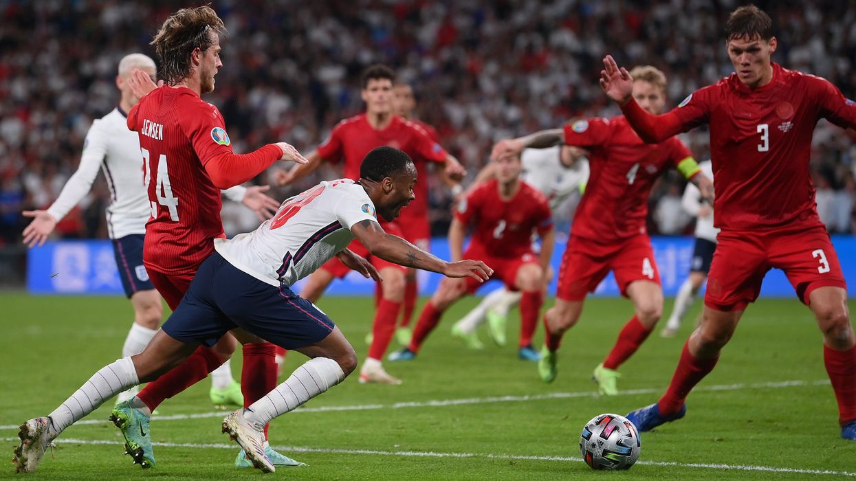 <p>The penalty moment as Raheem Sterling is fouled by Mathias Jensen </p>