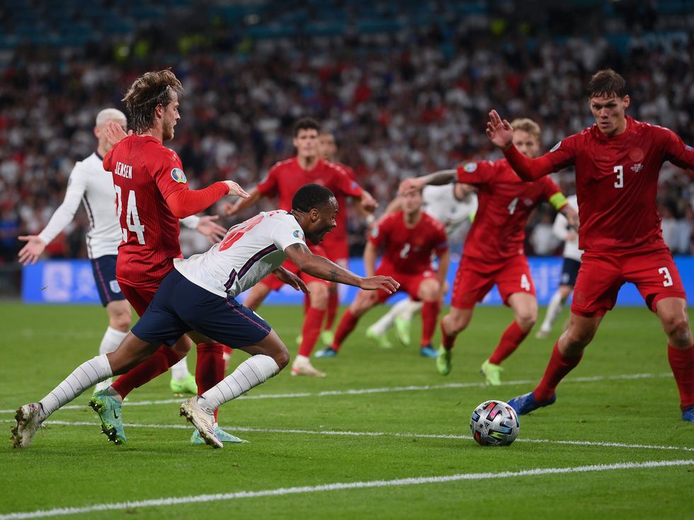 <p>The penalty moment as Raheem Sterling is fouled by Mathias Jensen </p>