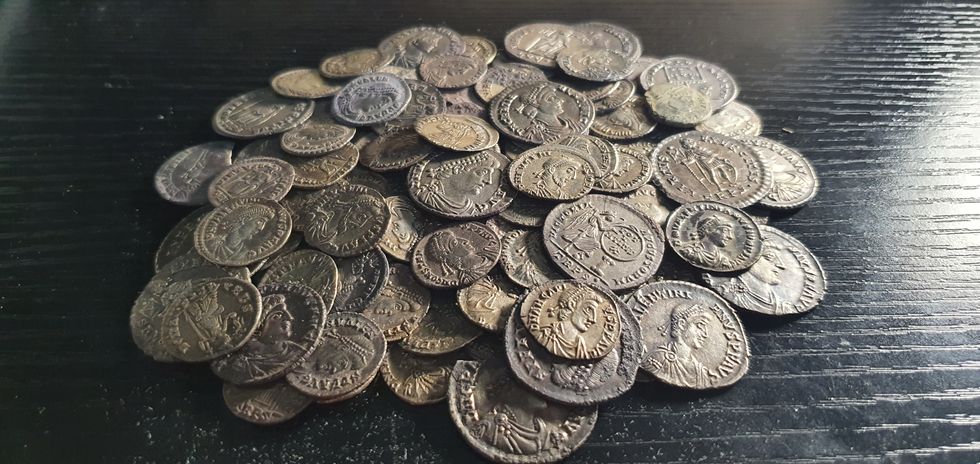 Detectorist friends find hoard of 161 Roman coins beneath their campsite