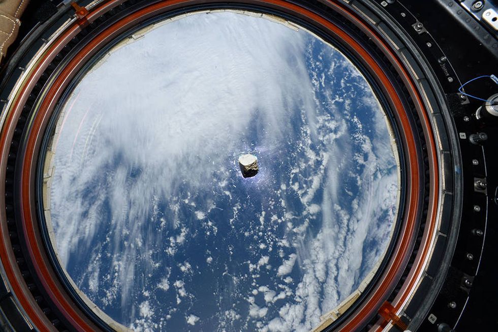 The piece of Martian rock is pictured floating in the International Space Station