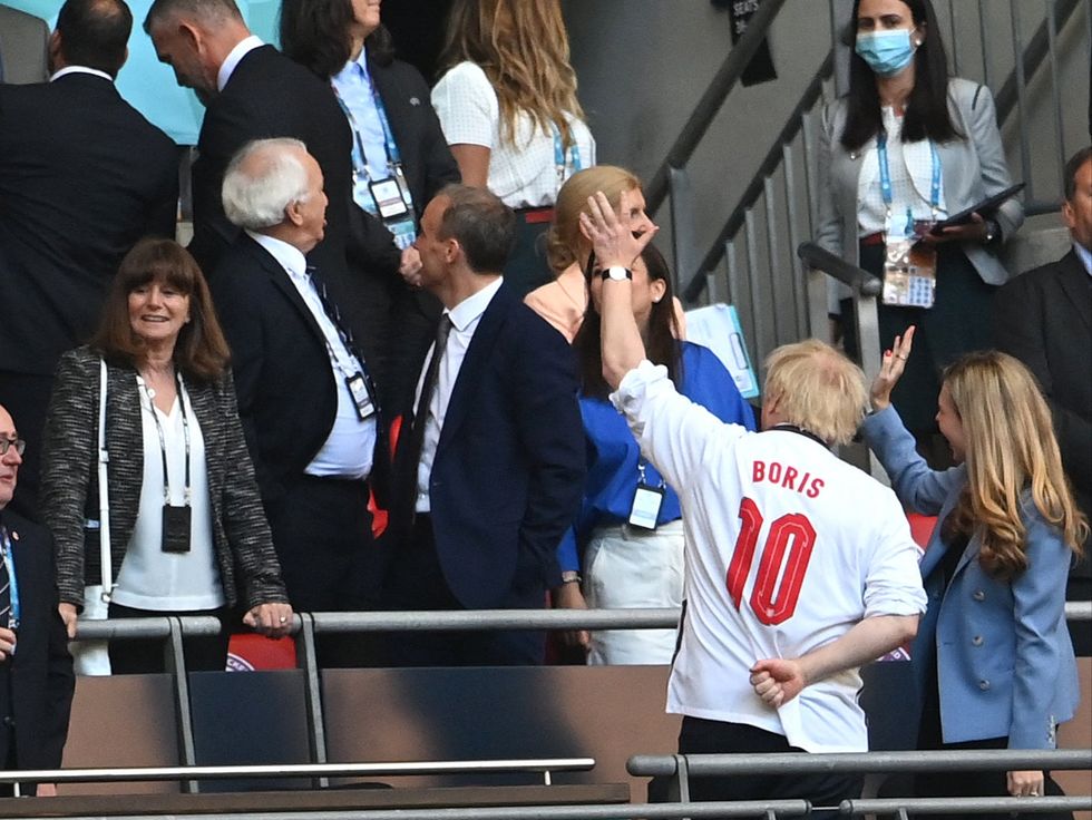 The prime minister is spotted wearing a personalised England shirt