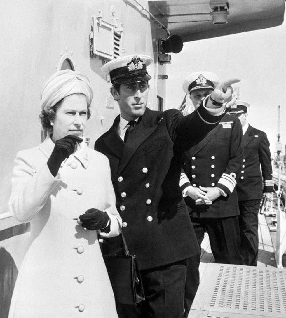 The Prince of Wales acts as guide for his mother, Queen Elizabeth II, during her visit to HMS Norfolk in 1972