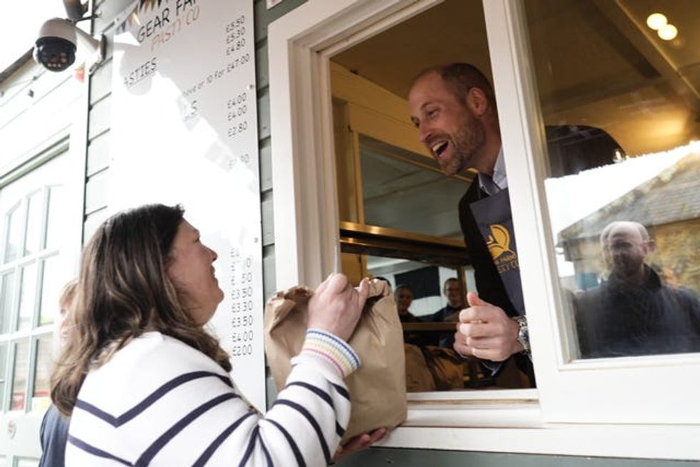 The Prince of Wales, known as the Duke of Cornwall while in Cornwall, serving customers during his visit to the Gear Farm Pasty Company, a family-run farm known for producing traditional Cornish pasties in St Martin, Helston, as he visits Cornwall for St Piran\u2019s Day