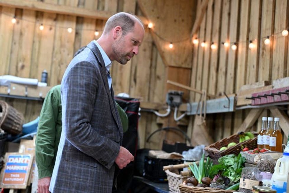 The Prince of Wales looks at the food produce on display in a barn as he tours the farm during a visit to the Apricot Centre in Dartington, Totnes,