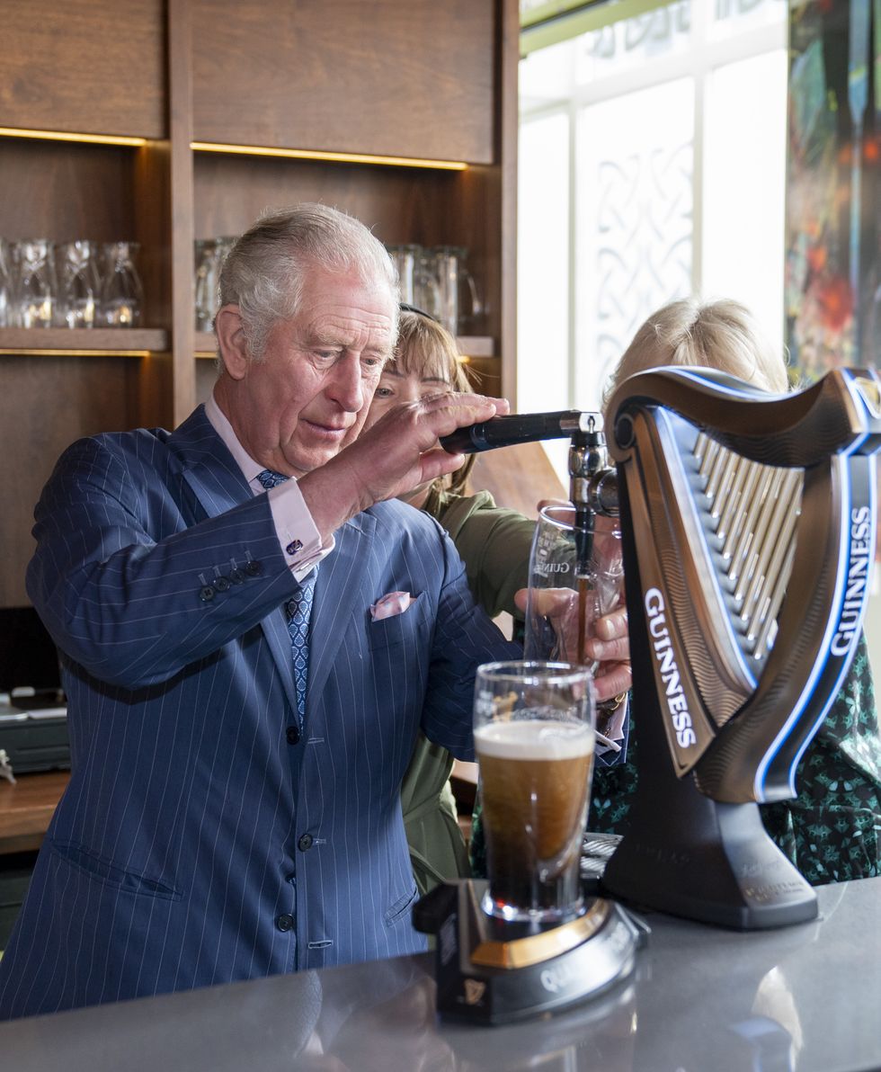 Charles pulls a pint of Guinness as he celebrates ahead of St Patrick’s Day