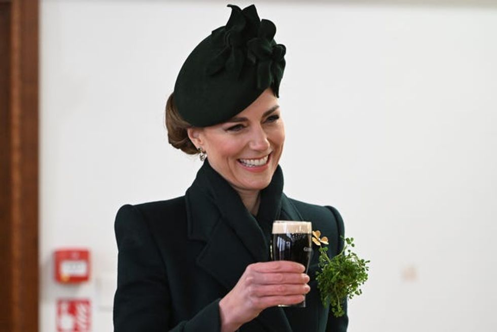 The Princess of Wales enjoys a glass of Guinness during the visit to the Irish Guards