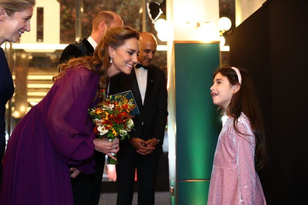 The Princess of Wales meets Evie Peters, seven, at the royal film performance and world premiere of Digger, at the Odeon Luxe in Leicester Square