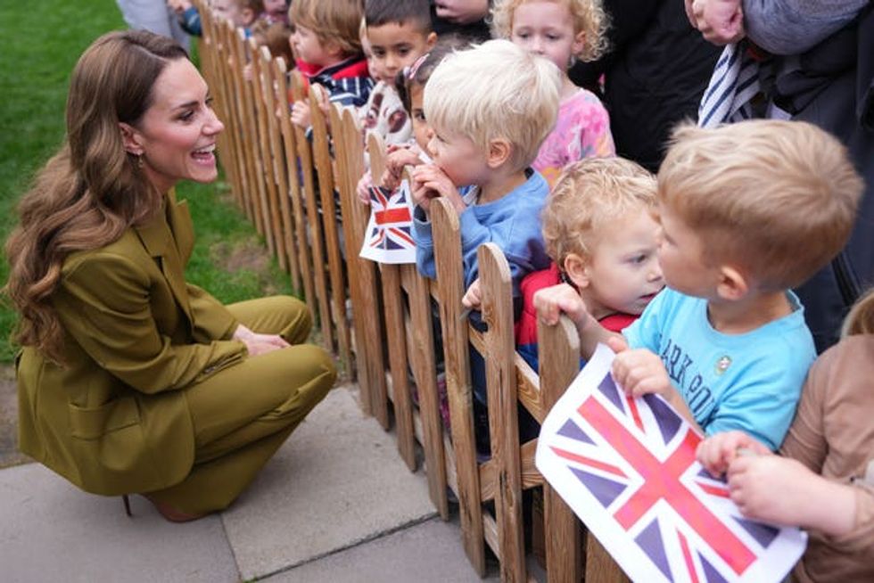 The Princess of Wales speaks to children waiting outside after a visit to Home-Start in Oxford
