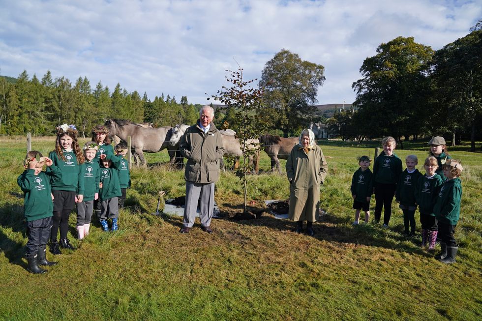 The Queen and Charles were joined by local schoolchildren for the tree-planting (Andrew Milligan/PA)